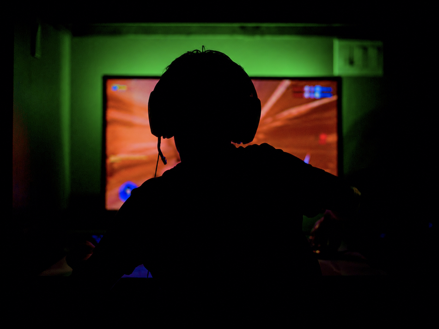 Gamer playing in a dark room